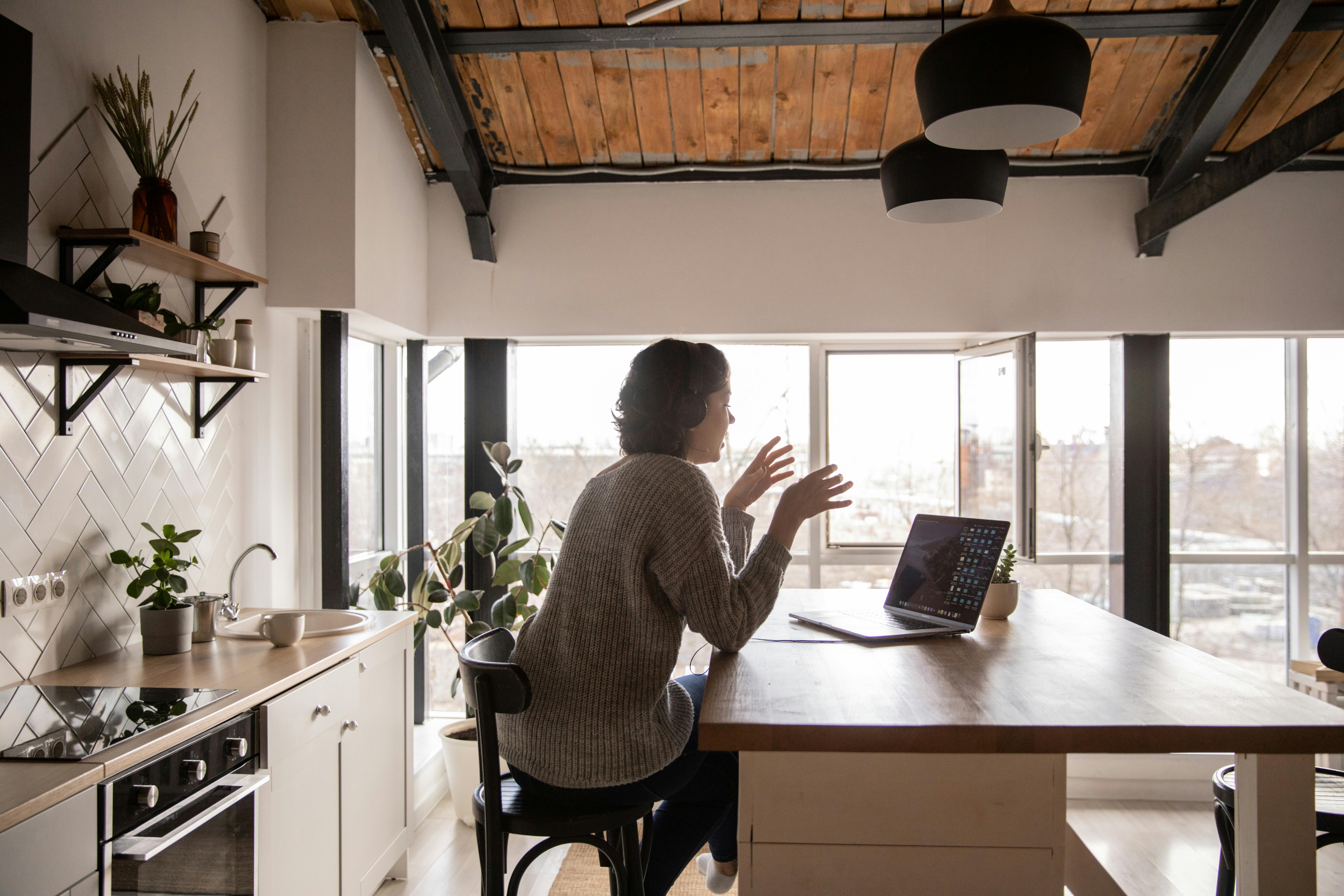 young-woman-surfing-laptop-in-kitchen