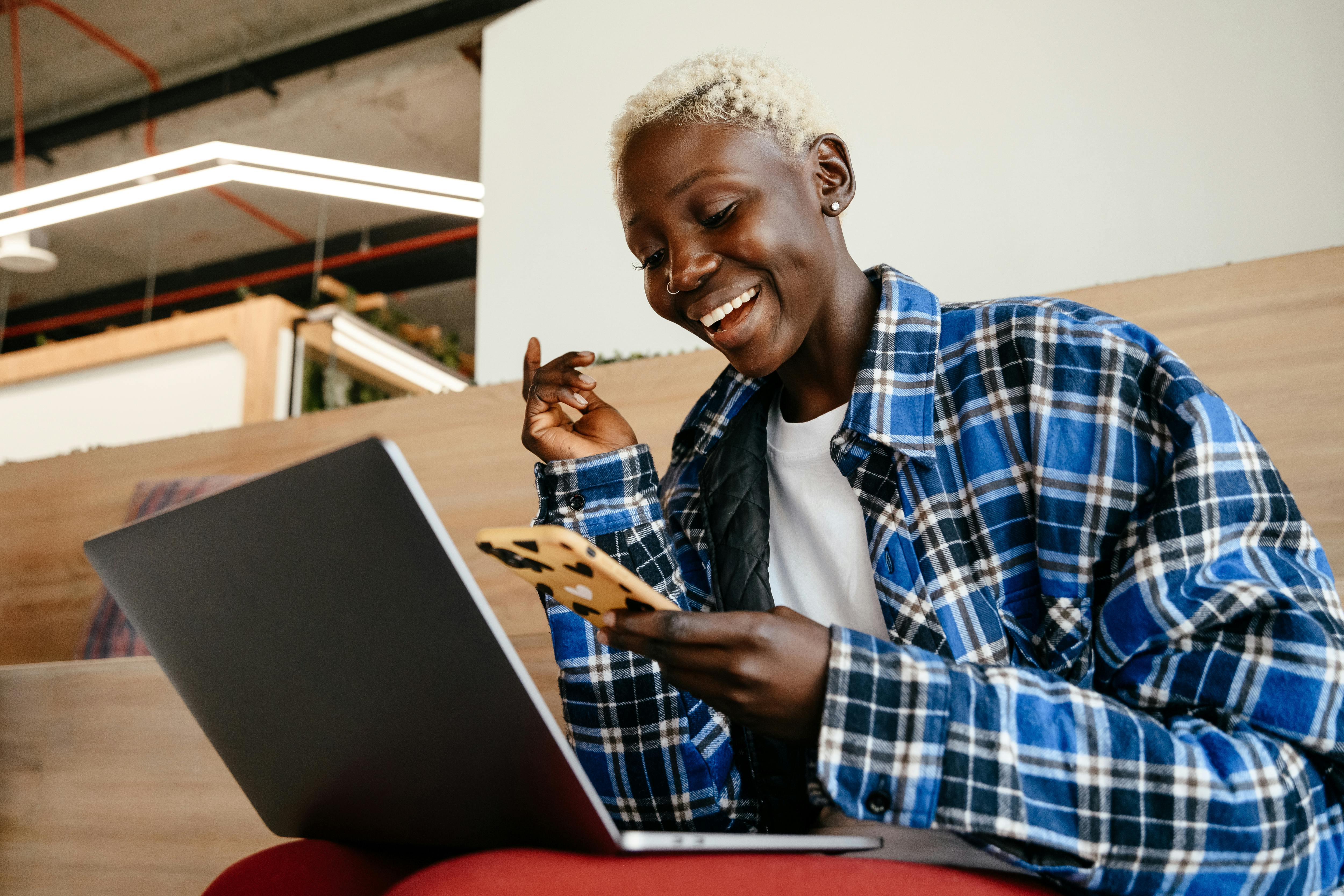 positive-black-woman-communicating-on-smartphone