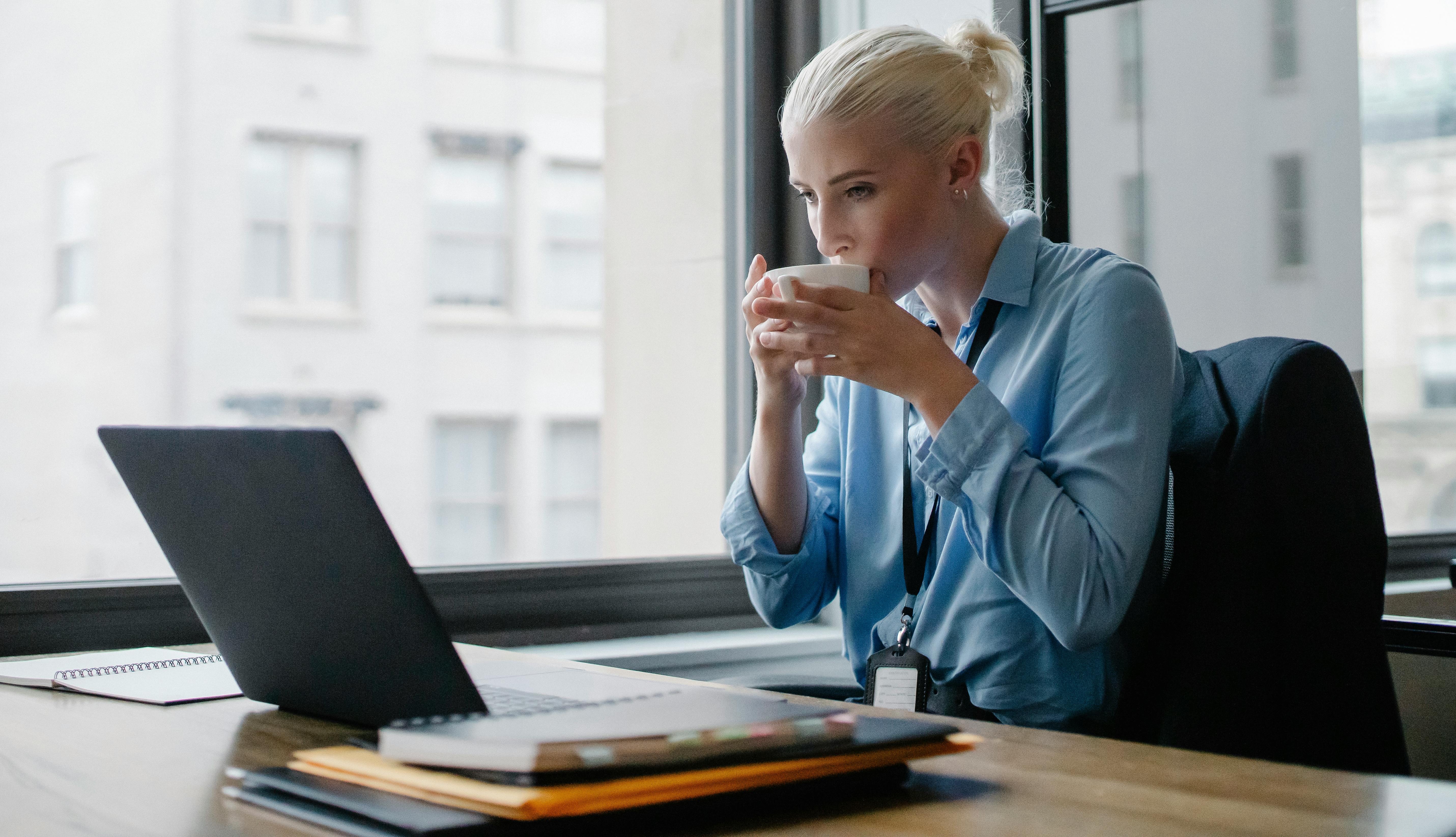 female-manager-drinking-coffee-at-workplace